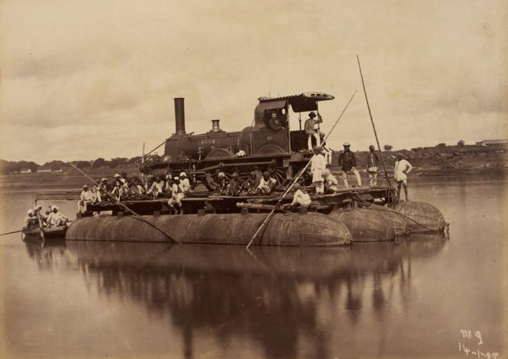 A steam train engine floating on a pontoon on the River Jumna. Photo 1085/2 51. BL Images online