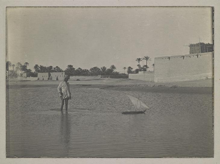 Photograph of a man with model dhow. Taken at Bandar-e Lengeh, 1918. Photo 496/6/18